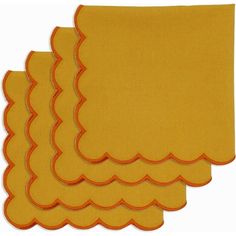 yellow scalloped placemats with orange trim on each set of four napkins