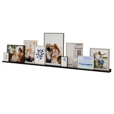 a black shelf with pictures and frames on it