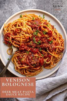 a white plate topped with spaghetti and sauce