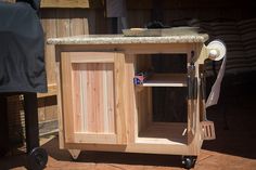 a kitchen island made out of wood on wheels