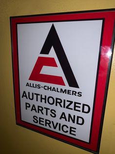 a sign that says authorized parts and service on the side of a yellow wall with red trim