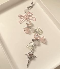 a white tray with three charms on it