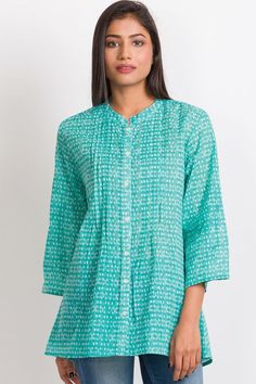 Our Amisha Cotton Tunic is a popular new addition to our sustainable apparel collection. Made with printed 100% cotton fabric, this fair trade tunic features a button down front and roll up button sleeves. These soft cotton tunic tops are free size, and are designed for an elegant, comfortable fit up to size XXL. One size fits most. Cotton Printed Tops With 3/4 Sleeves, Printed Cotton Tops With 3/4 Sleeves, Cotton Blouse With Roll-up Sleeves For Daywear, Cotton Tunic Blouse With Buttons, Green Blouse With Placket, Green Tunic For Daywear, Green Long Sleeve Tunic With Printed Motifs, Cotton Kurta With 3/4 Sleeves For Spring, Green Straight Kurta Blouse For Summer