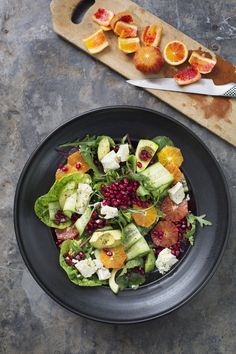 a pan filled with lots of food on top of a white table next to silverware