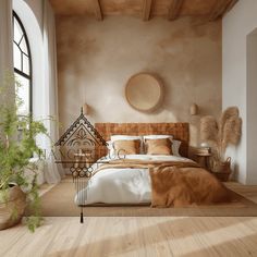 a large bed in a bedroom next to a window with a plant on the side