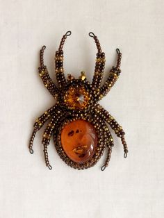 "Buy the Spider jewelry as unique Halloween brooch. Spider pin has a has a size approximately 2*3 inches (5*7,5 cm). This Beaded insect brooch is the best Halloween gift. A Spider jewelry brooch is carefully bead embroidered on leather using Czech crystals, seed beads. The central element can be made of imitation of amber, other gemstone or crystal to your order. * Size gold insect brooch: approx. 2*3 inches (5*7,5 cm) with a sweep of all his paws * Color customization for custom orders is avail Spider Jewelry, Spider Crafts, Beaded Spiders, Halloween Pins, Unique Halloween, Bead Embroidery Jewelry, Czech Crystal, Embroidery Jewelry, Halloween Jewelry