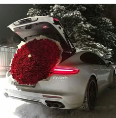 the back end of a car with flowers in it