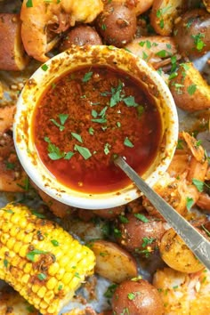 a plate with shrimp and corn on the cob