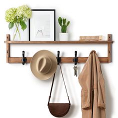 a hat, coat rack and purse hanging on a wall