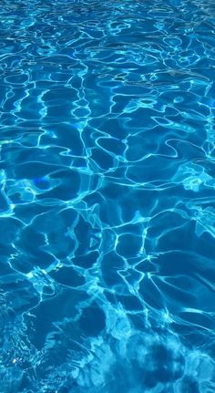 the water is blue and clear with ripples on it's surface in this pool