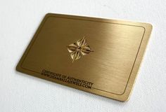 a gold credit card sitting on top of a white table