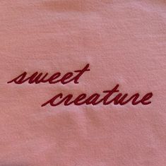 a pink shirt with the words sweet creature embroidered on it