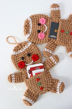 two crocheted gingerbreads are sitting next to each other