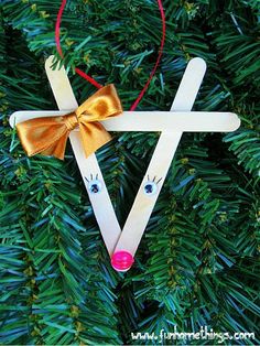 an ornament made out of popsicle sticks is hanging on a christmas tree