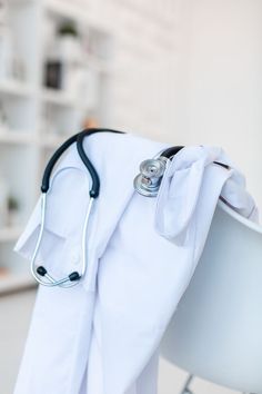 a white chair with a stethoscope on it's back and a medical bag attached to the seat