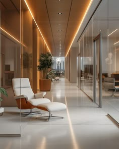 an office lobby with a chair and plant in the center, along with glass walls