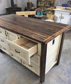 a kitchen island made out of wood and drawers