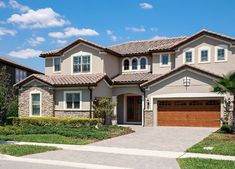 a large house with two car garages in front of it