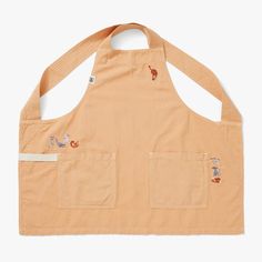 an orange apron with embroidered animals on it