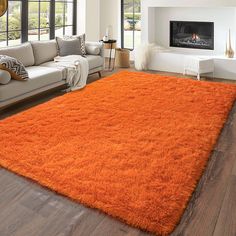 an orange rug in the middle of a living room