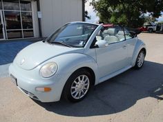 a white convertible car parked in front of a building