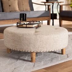 a living room with a couch, chair and coffee table on top of a rug