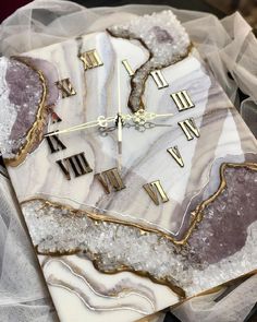 a marble clock with roman numerals on it