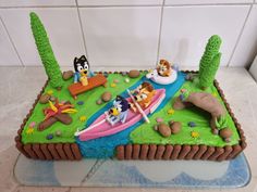 a birthday cake decorated with cartoon characters on it