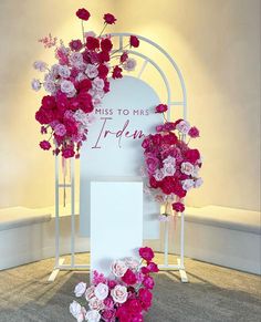 pink and white flowers on display in front of a sign that says miss to mrs