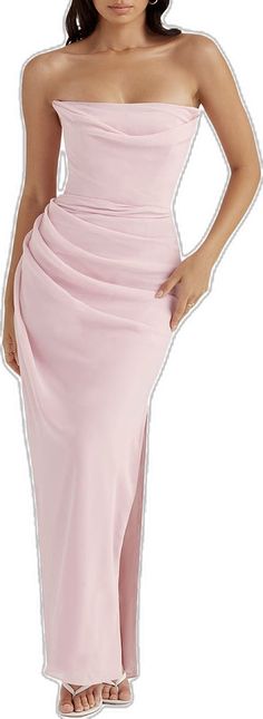 a woman in a pink dress with her hands on her hips