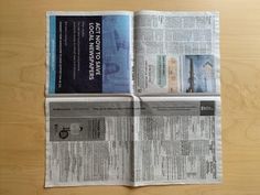 the newspaper is folded up and ready to be read