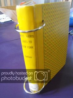 a yellow binder sitting on top of a purple table