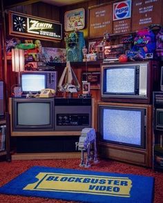 a room with several televisions and other items on the floor in front of them