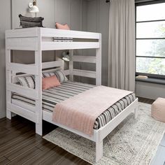 a white bunk bed sitting next to a window in a room with hardwood flooring