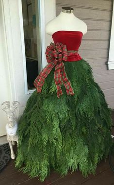 a dress made out of grass with a bow on it