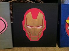 three canvases with iron man and captain america logos on them are sitting on a table