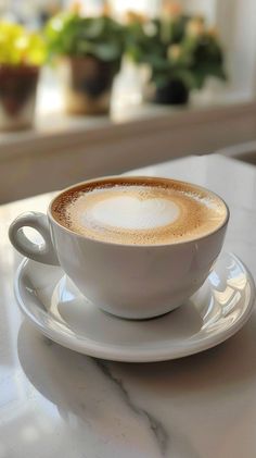 a cappuccino is sitting on a saucer