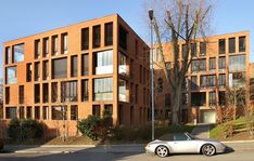 a car is parked in front of an apartment building