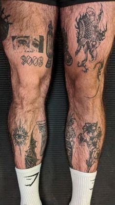 the legs and ankles of a man with tattoos on his body, both wearing socks