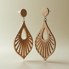 the wooden earrings are designed to look like an intricate design