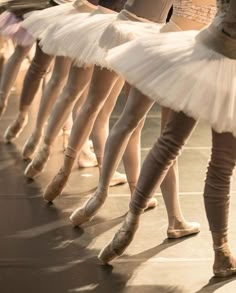 several ballerinas are lined up on the floor