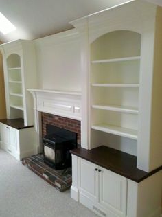 a living room with a fire place and bookshelves