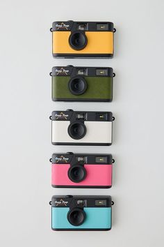 four different colored cameras sitting next to each other