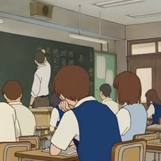 there are many people sitting at desks in front of a chalkboard with writing on it