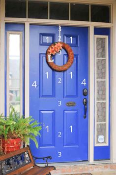 a blue front door with a wreath on it