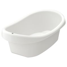 a white bath tub sitting on top of a white floor