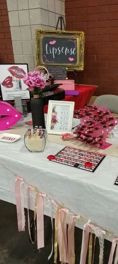 the table is covered with pink and black items for valentine's day party decorations