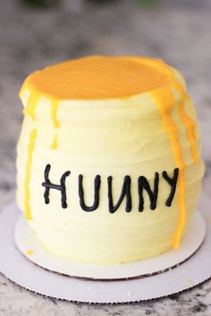 a cake with the word humpy on it and dripping yellow icing, sitting on a plate