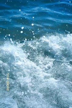 the water is blue and foamy with small bubbles