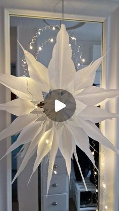 a large white paper flower hanging from the ceiling